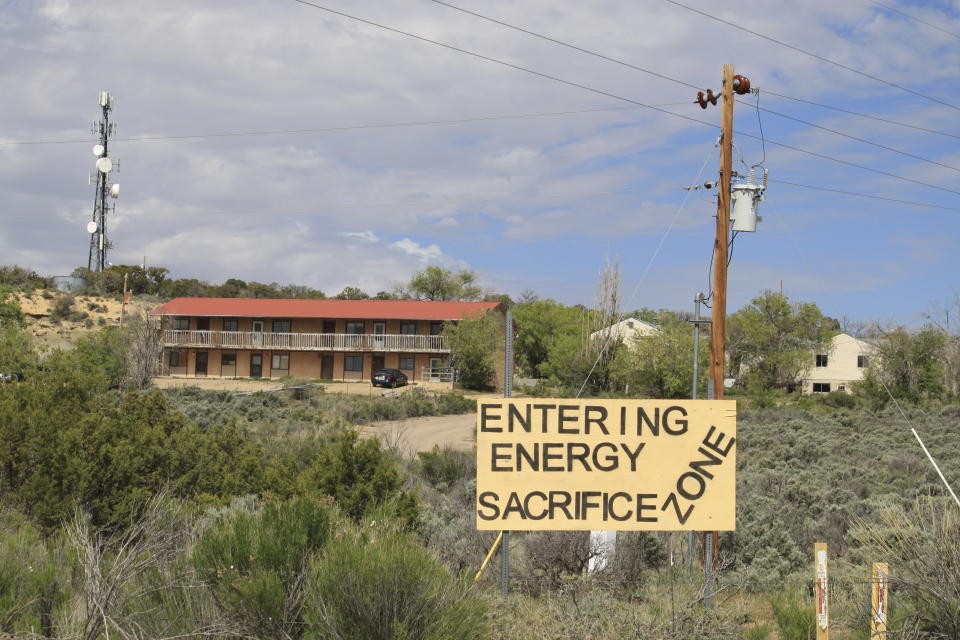 A sign of protest stands on a hillside in Counselor, N.M., on May 17, 2023. On Thursday, June 1, 2023, New Mexico Land Commissioner Stephanie Garcia Richard issued an executive order that includes a ban on all new oil and gas leases on state trust land within a mile (1.6 kilometers) of schools or other educational institutions, including day care centers, preschools and sports facilities that students use. (AP Photo/Susan Montoya Bryan)