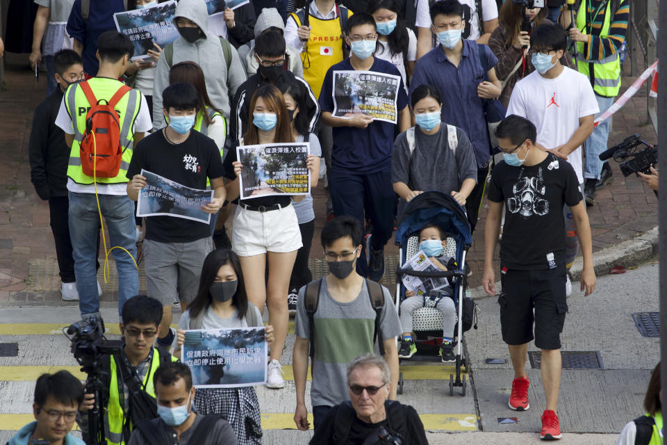 Parents and children participate in a rally to protest against the exposure of children to tear gas by police in Hong Kong, Saturday, Nov. 23, 2019. President Donald Trump on Friday wouldn't commit to signing bipartisan legislation supporting pro-democracy activists in Hong Kong as he tries to work out a trade deal with China. (AP Photo/Ng Han Guan)