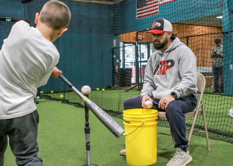 Hitting Instructor Sean Riley oversees James Reardon as he puts in his work doing Tee drills.