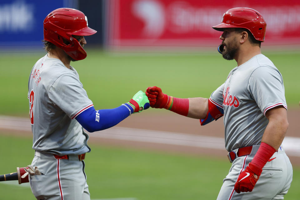 Philadelphia Phillies' Kyle Schwarber, right, celebrates with Bryce Harper (3) after hitting a solo home run during the first inning of a baseball game against the San Diego Padres, Friday, April 26, 2024, in San Diego. (AP Photo/Brandon Sloter)