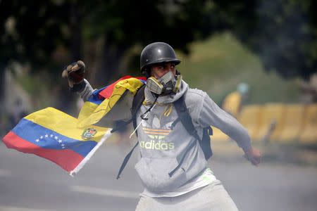 A demonstrator clashes with riot security forces while rallying against Venezuela's President Nicolas Maduro in Caracas, Venezuela, May 31, 2017. REUTERS/Marco Bello
