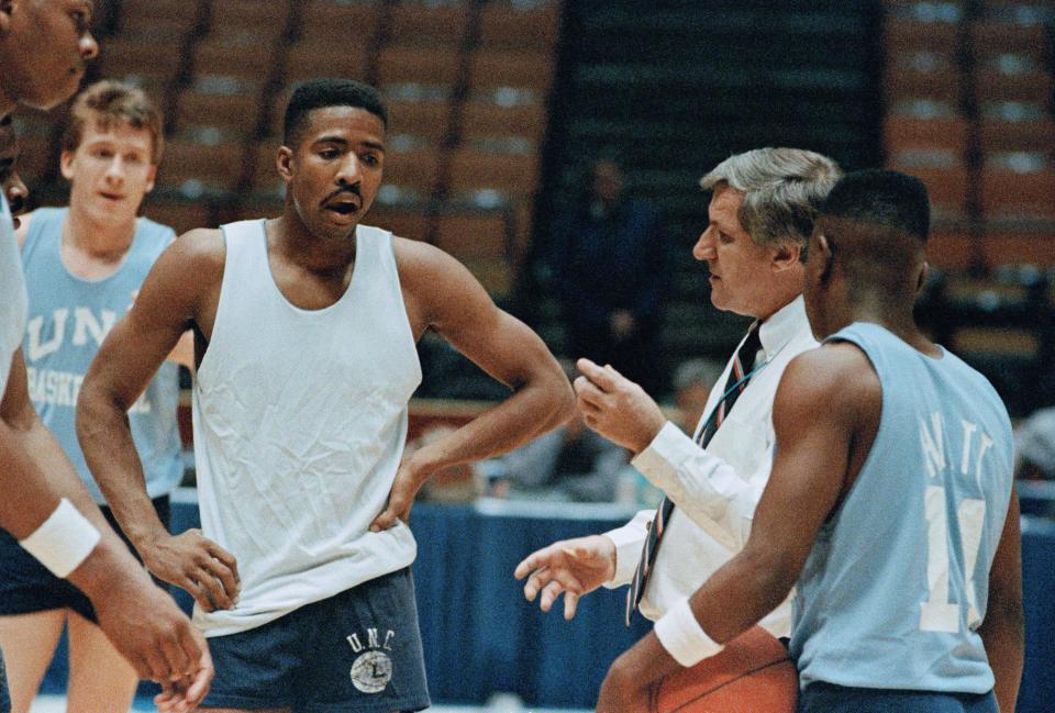 University of North Carolina head coach Dean Smith, right, has a few words with player Kenny Smith, left, during NCAA Practice at the Meadowlands Arena in East Rutherford on Wednesday, March 19, 1987. (AP Photo/Wilbur Funches)