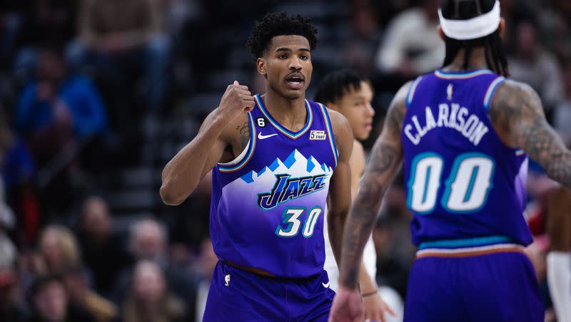 Utah Jazz guard Ochai Agbaji (30) signals to teammate Jordan Clarkson during a game at Vivint Arena in Salt Lake City on Feb. 23, 2023.