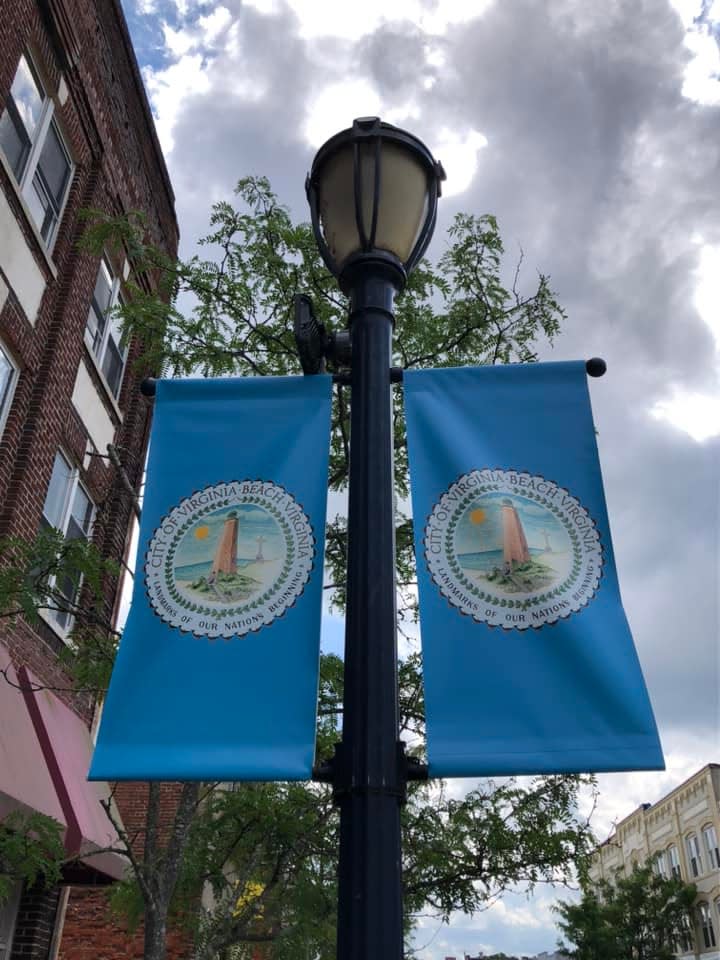Virginia Beach street banners line E. Broadway in downtown Hopewell as part of a movie set, possibly for a Pharrell Williams musical.