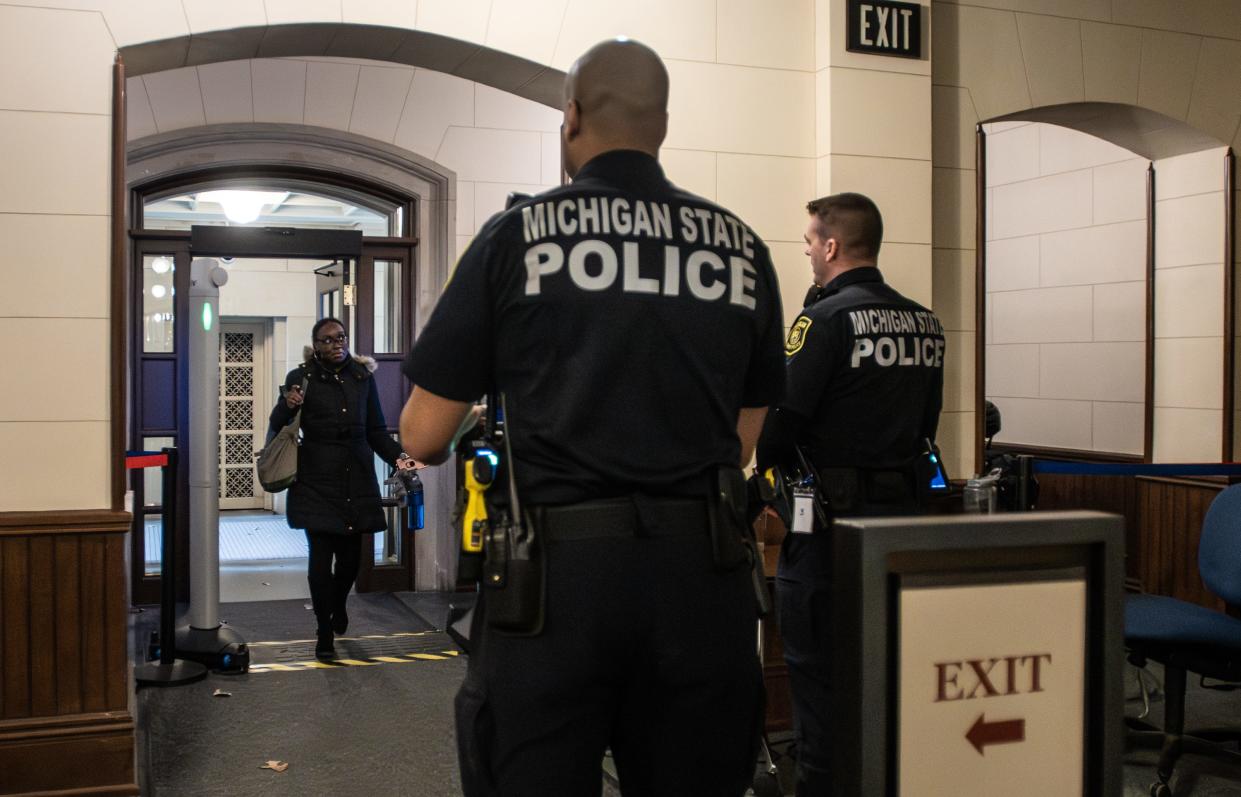 Troopers from the Michigan State Police monitor the main entryway of the state Capitol building, Wednesday, March 20, 2024.