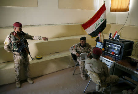 Iraqi soldiers work at a radio station at Makhmour base, Iraq, April 17, 2016. REUTERS/Ahmed Jadallah/File Photo