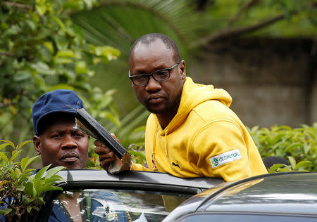 FILE PHOTO: Activist Pastor Evan Mawarire is taken into a vehicle by police outside his home in Harare, Zimbabwe, January 16, 2019. REUTERS/Philimon Bulawayo/File Photo