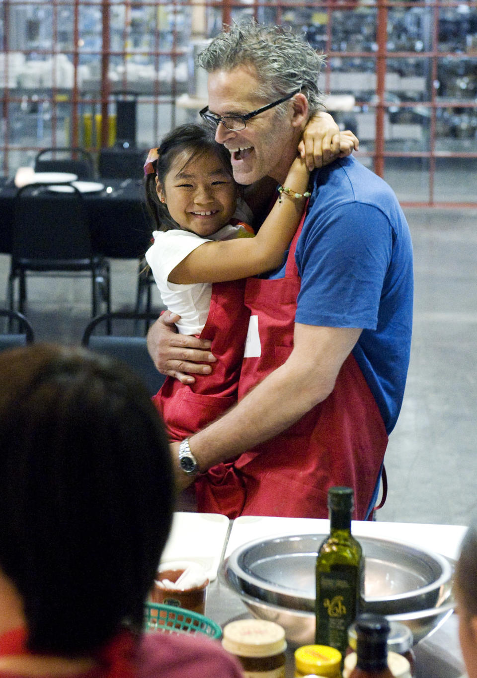 Sascha Friend, 8, of Irvine, Calif., hugs her father Russell during a a Fathers Day cooking class at Surfas Culinary District in Costa Mesa's, Calif., SoCo Collection, Sunday, June 16, 2013. (AP Photo/The Orange County Register, Cindy Yamanaka)