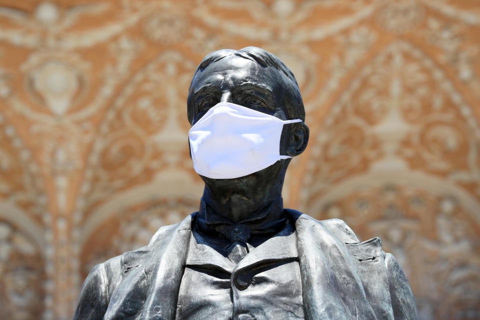 SAINT AUGUSTINE, FLORIDA - MAY 04: A mask is seen on the statue of Henry M. Flagler as the state of Florida enters phase one of the plan to reopen the state on May 04, 2020 in Saint Augustine, Florida. Restaurants, retailers, beaches and some state parks reopen today with caveats, as the state continues to ease restrictions put in place to contain the coronavirus (COVID-19). (Photo by Sam Greenwood/Getty Images)