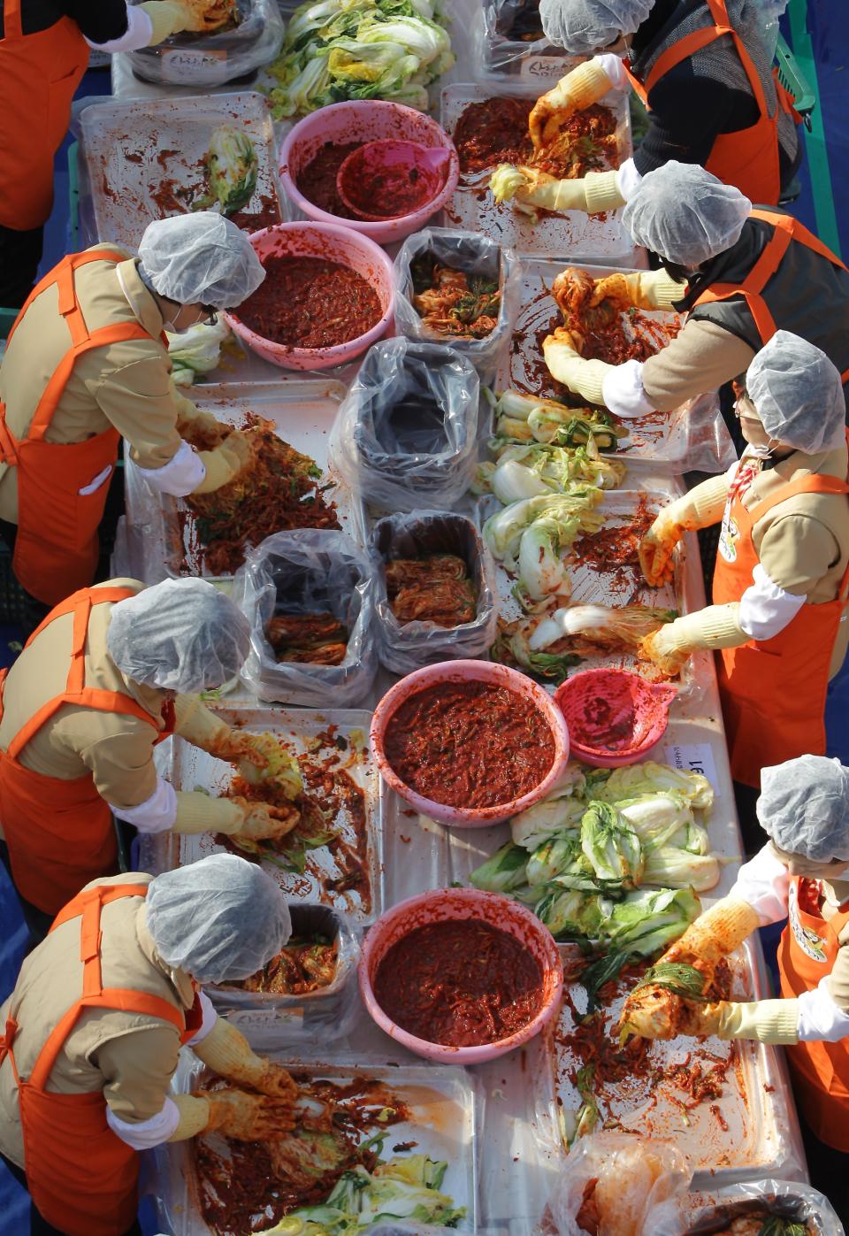 SEOUL, SOUTH KOREA - NOVEMBER 15: More than two thousands of housewives make Kimchi for donation to the poor in preparation for winter in front of City Hall on November 15, 2012 in Seoul, South Korea. Kimchi is a traditional Korean dish of fermented vegetables usually mixed with chili and eaten with rice or served as a side dish to a main meal. (Photo by Chung Sung-Jun/Getty Images)
