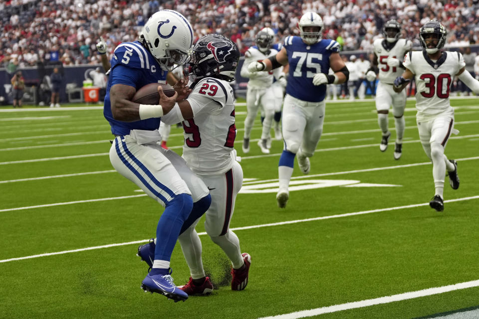 Indianapolis Colts quarterback Anthony Richardson (5) is hit by Houston Texans safety M.J. Stewart (29) as he runs for a touchdown during the first half of an NFL football game Sunday, Sept. 17, 2023, in Houston. (AP Photo/David J. Phillip)