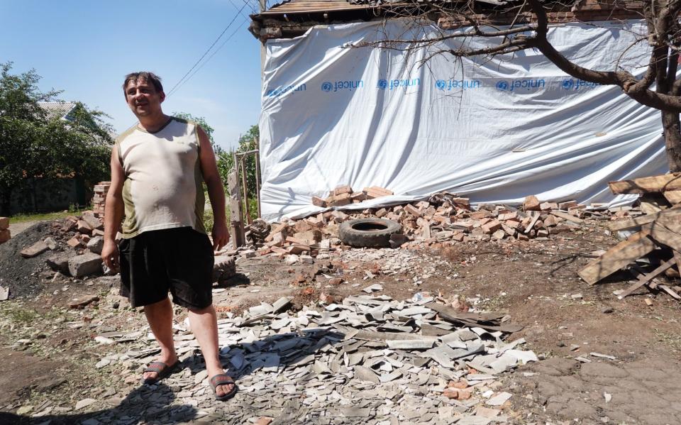 A man looks over damage to his neighbor's home after it was hit by artillery fire in Sloviansk - Scott Olson 