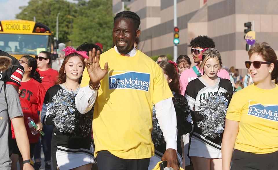Des Moines School District superintendent Ian Roberts waves to the crowd while passing through Grand Avenue during the Iowa State Fair Parade on Aug. 9 in Des Moines, Iowa.