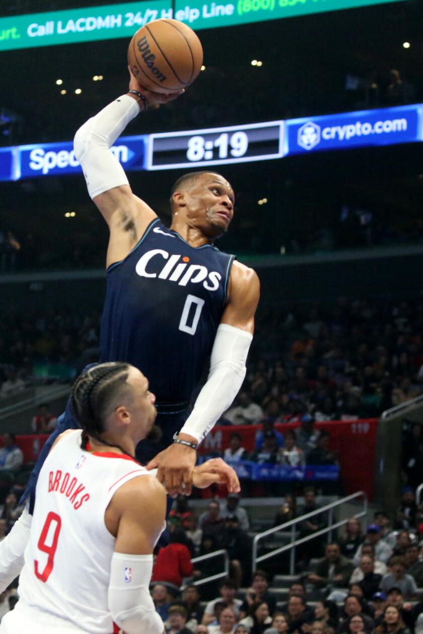 Clippers guard Russell Westbrook gets fouled by Rockets guard Dillon Brooks in the first half at Crypto.com Arena.