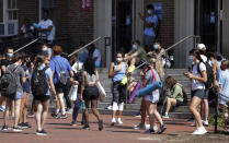 University of North Carolina students wait outside of Woolen Gym on the Chapel Hill, N.C., campus as they wait to enter for a fitness class Monday, Aug. 17, 2020. The University announced minutes before that all classes will be moved online starting Wednesday, Aug. 19 due to COVID clusters on campus. (Julia Wall/The News & Observer via AP)