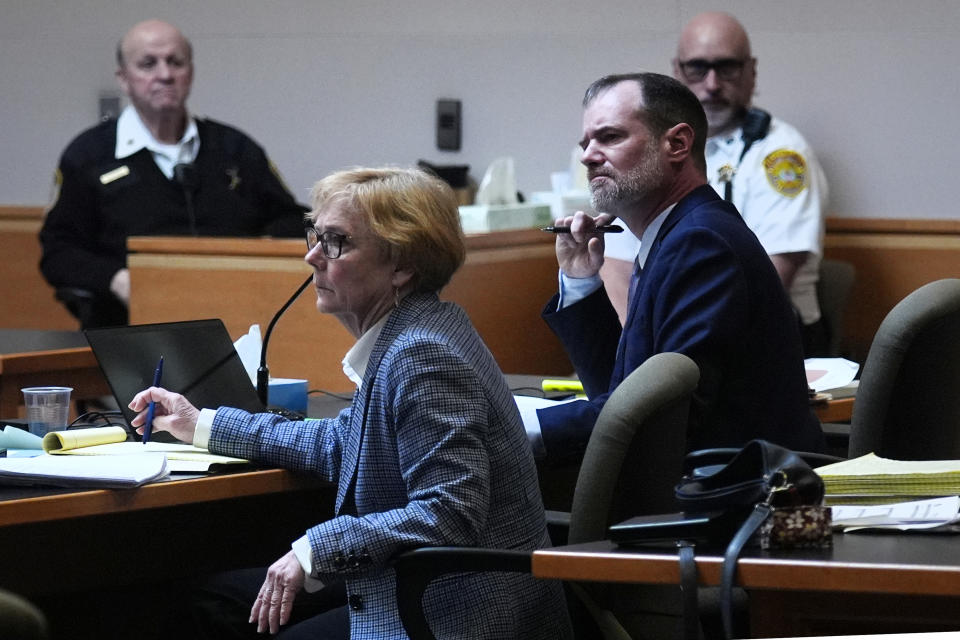 Defense attorneys James Brooks, right, and Caroline Smith listen to the prosecution address the court during the trial of the Adam Montgomery at Hillsborough County Superior Court, Tuesday, Feb. 20, 2024, in Manchester, N.H. Montgomery is facing second-degree murder and other charges in the death of his daughter, Harmony. (AP Photo/Charles Krupa, Pool)