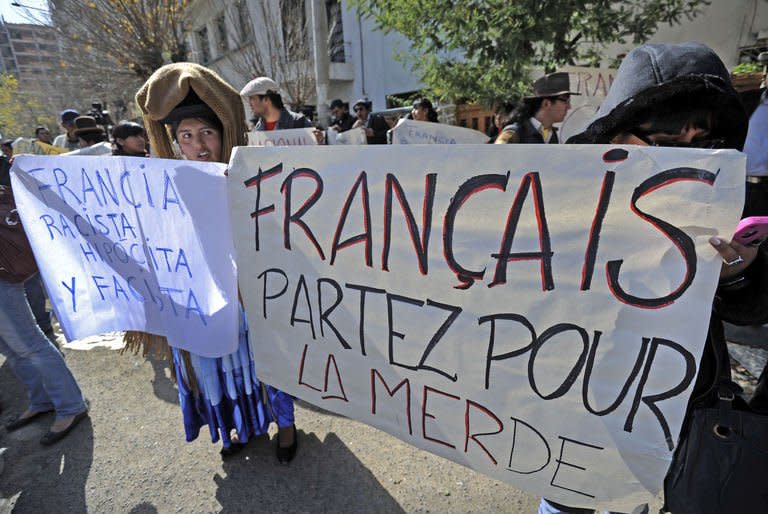 Bolivian protestors demonstrate in front of the French embassy in La Paz on June 3, 2013. About 100 protesters threw stones and burned the French flag at Paris's embassy in La Paz Wednesday, as Bolivians expressed rage over France's decision to deny their president's aircraft permission to enter its airspace