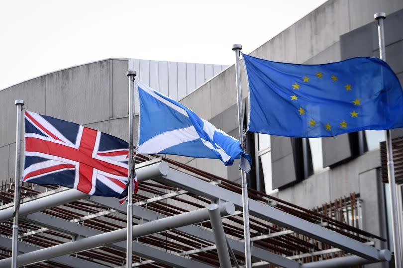 The Union Flag, Saltire of Scotland and EU flag fly outside the entrance to the Scottish Parliament building in Edinburgh on January 29, 2020. (Photo by Andy Buchanan / AFP) (Photo by ANDY BUCHANAN/AFP via Getty Images)