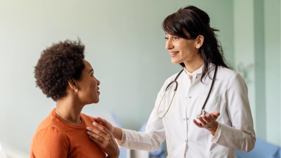 period diarrhea: Female patient speaking with her pediatrician in a doctors office