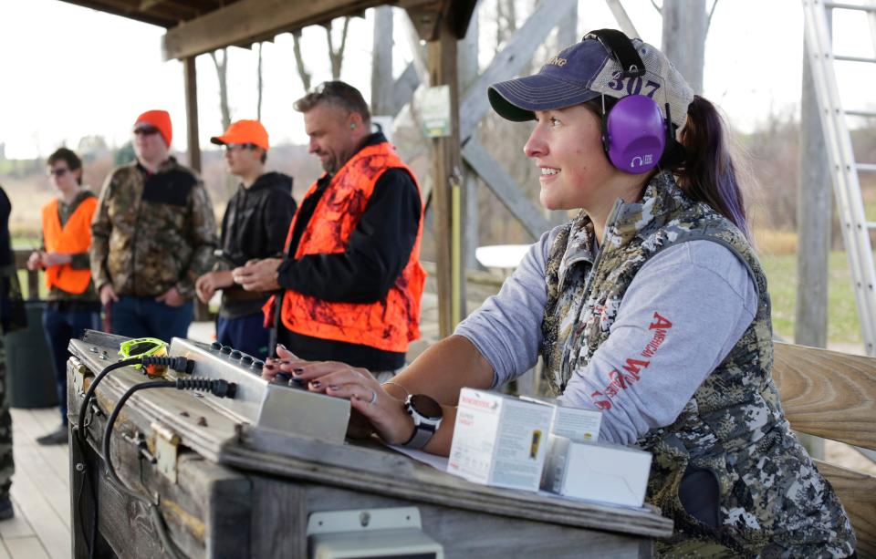 Random Lake High School life sciences teacher Natalie Weeks releases clay pigeons during a skeet shooting portion during a wilderness science class at the Highland Sportmen’s Club, Wednesday, November 9, 2022, in Cascade, Wis.