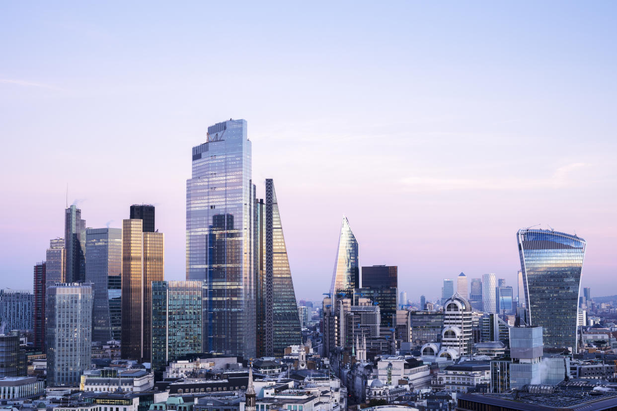 UK, London, looking East with view of the financial district and Canary Wharf against sky at dusk