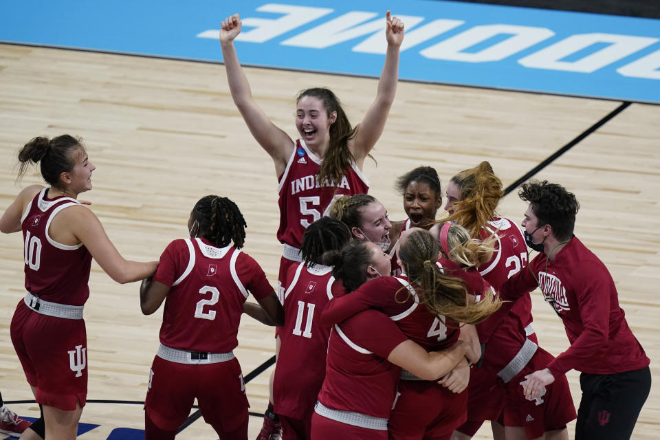 Indiana celebrate their win over North Carolina State in a college basketball game in the Sweet Sixteen round of the women's NCAA tournament at the Alamodome in San Antonio, Saturday, March 27, 2021. (AP Photo/Eric Gay)