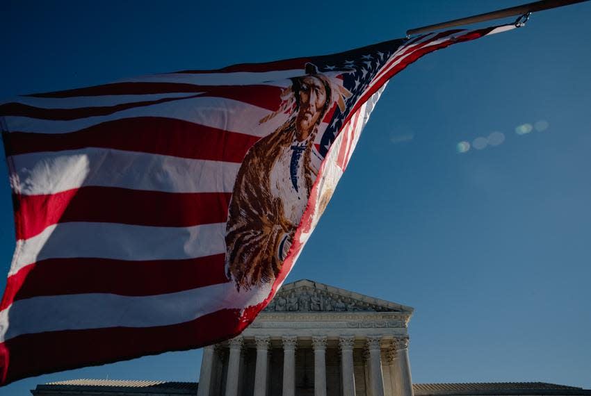 A flag flies outside the Supreme Court on Wednesday as arguments were heard challenging the constitutionality of the Indian Child Welfare Act.