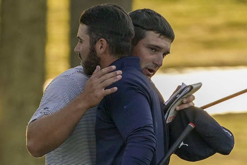 Bryson DeChambeau, of the United States, right, hugs Matthew Wolff, of the United States, after winning the US Open Golf Championship, Sunday, Sept. 20, 2020, in Mamaroneck, N.Y. (AP Photo/John Minchillo)