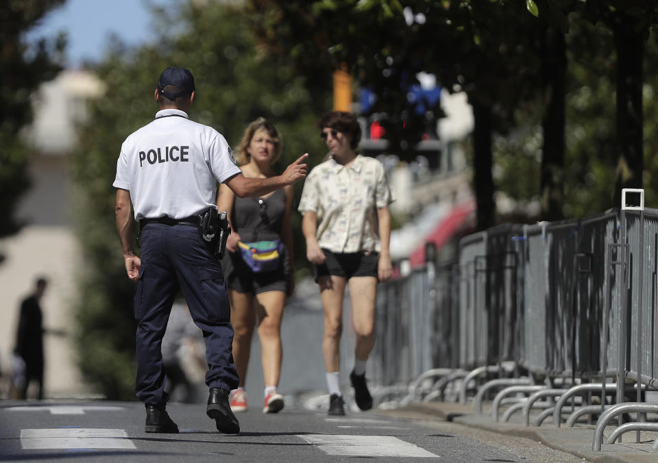 A police officer gestures to pedestrians inside the restricted zone as security is ramped up ahead of the G-7 summit in Biarritz, France Friday, Aug. 23, 2019. U.S. President Donald Trump will join host French President Emmanuel Macron and the leaders of Britain, Germany, Japan, Canada and Italy for the annual G-7 summit in the elegant resort town of Biarritz. (AP Photo/Markus Schreiber)