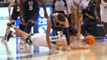 BYU guard Alex Barcello (13) and Utah State forward Brandon Horvath, top, battle for a loose ball in the first half during an NCAA college basketball game Wednesday, Dec. 8, 2021, in Provo, Utah. (AP Photo/Rick Bowmer)