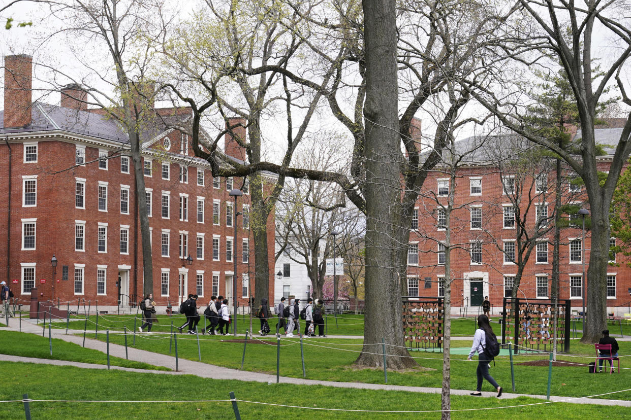 FILE - Students walk through Harvard Yard, April 27, 2022, on the campus of Harvard University in Cambridge, Mass. A new poll from The Associated Press-NORC Center for Public Affairs Research found that 63% of Americans say the Supreme Court should not stop colleges from considering race or ethnicity in their admission systems. The Supreme Court is expected to rule soon on lawsuits challenging admissions systems at Harvard and the University of North Carolina. (AP Photo/Charles Krupa, File)