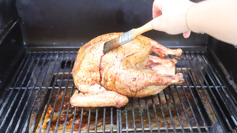 Hand brushing glaze on turkey