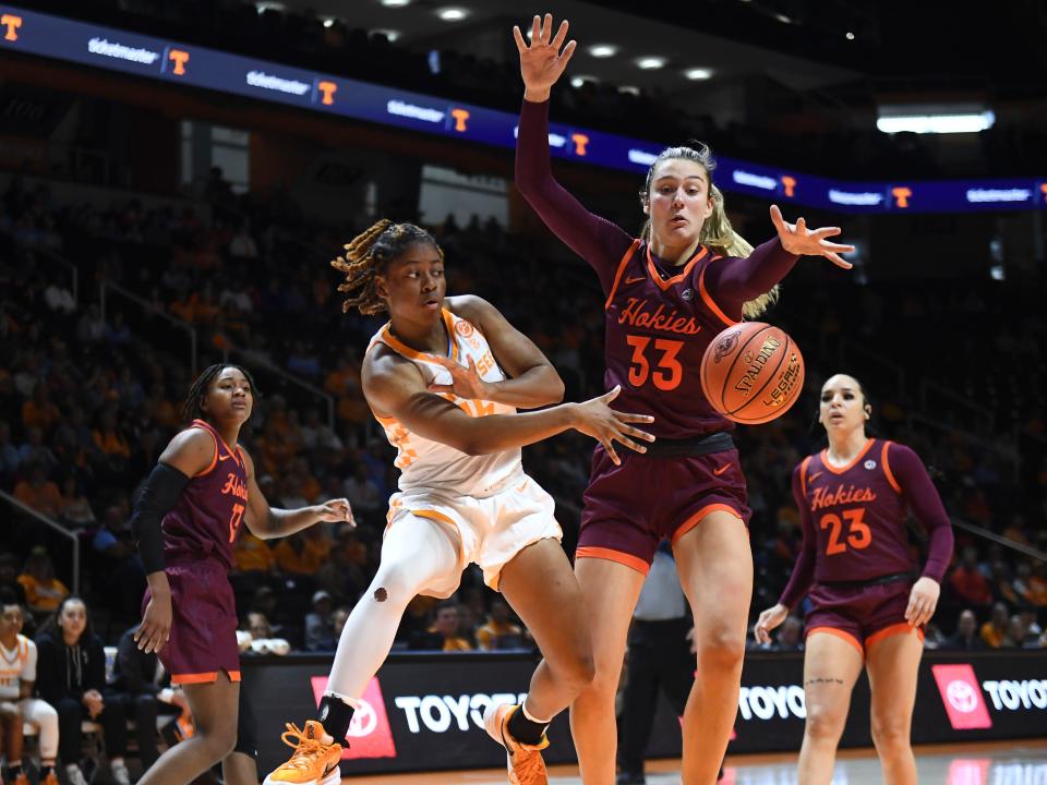 Tennessee guard Jasmine Powell (15) passes the ball away after driving past Virginia Tech center Elizabeth Kitley (33) during the NCAA college basketball game between the Tennessee Lady Vols and Virginia Tech Hokies in Knoxville, Tenn. on Sunday, December 4, 2022. 