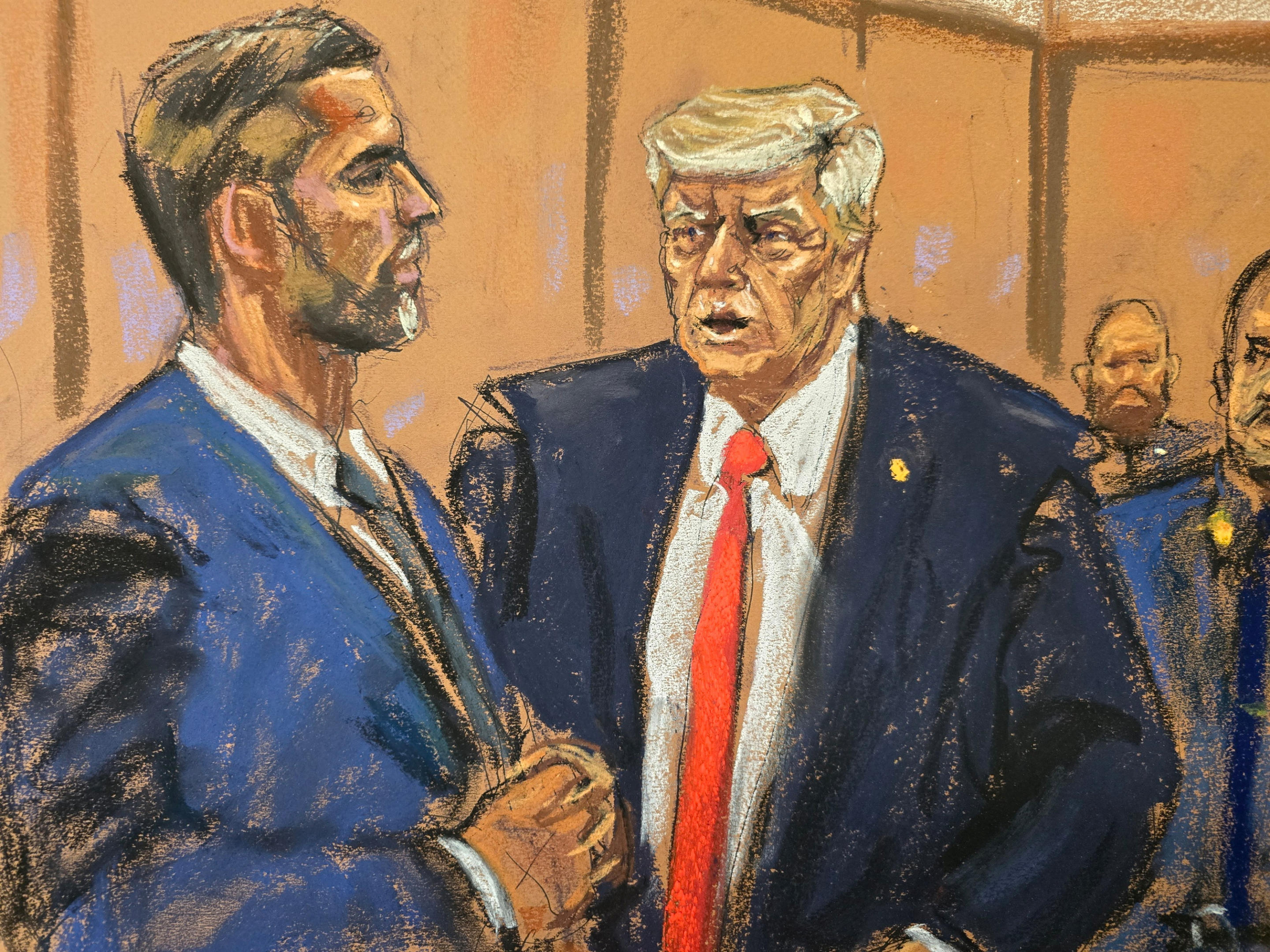 Donald Trump chats with his son Eric Trump during a break in the trial on April 30. 