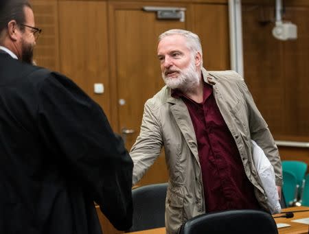 Defendant Swiss man Daniel M., accused of spying on a German tax authority to find out how it obtained details of secret Swiss bank accounts set up by Germans to avoid tax, talks to his lawyer Robert Kain (L) before the start of his trial on espionage charges, in the Higher Regional Court in Frankfurt am Main, Germany October 18, 2017. REUTERS Andreas Arnold/Pool