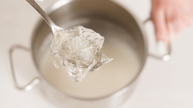 Gelatin on a spoon over a pot