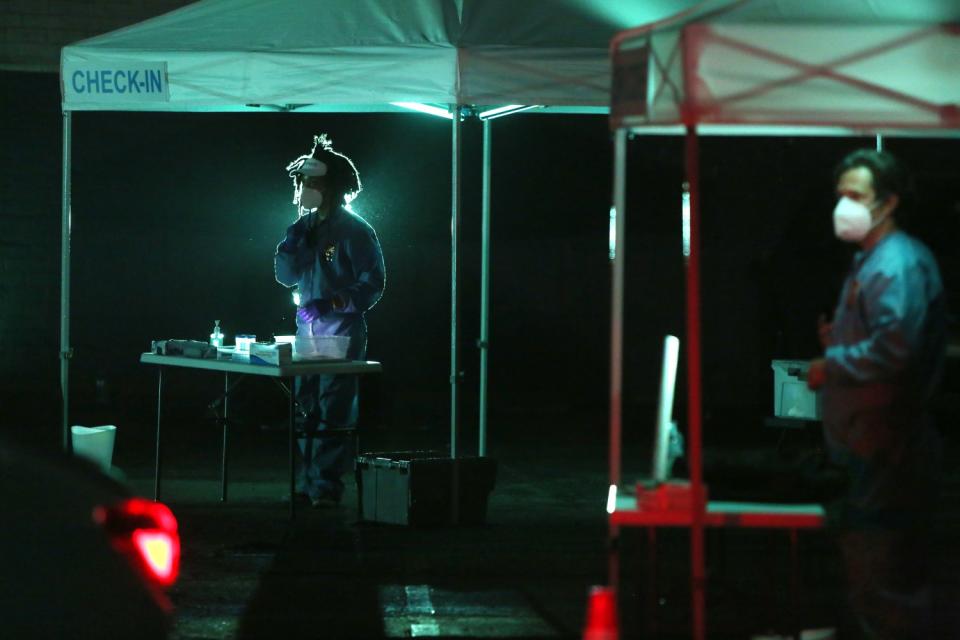 Actors rehearse "5711 Avalon," set up in a parking lot to depict a drive-through COVID-19 testing site.