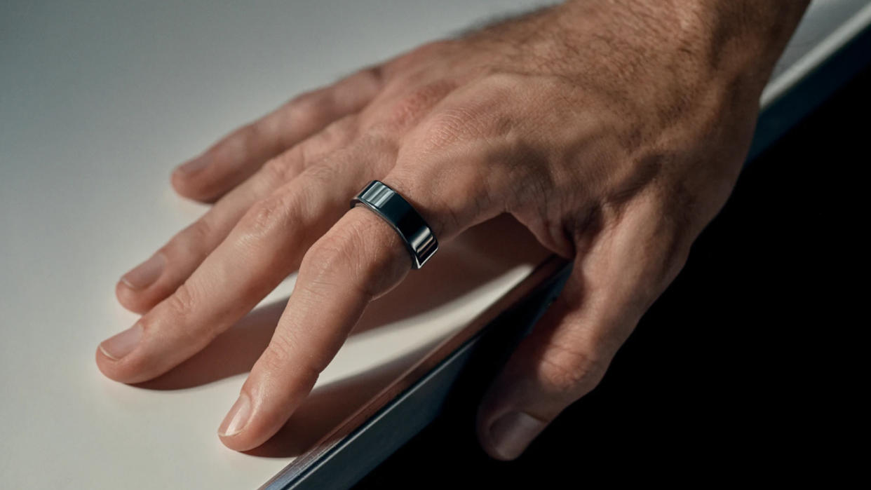  Oura Ring in black on male hand. 
