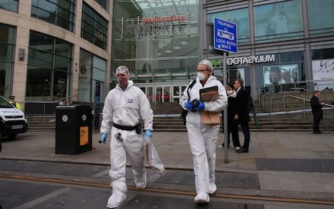 Police forensics officers work outside Arndale Centre shopping complex in Manchester, northwest England on October 11, 2019, following a series of stabbings - Credit: LINDSEY PARNABY/AFP