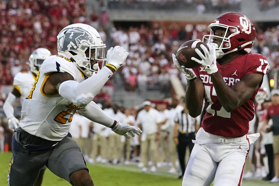 Oklahoma wide receiver Marvin Mims (17) catches a touchdown pass in front of Kent State safety JoJo Evans (23) in the first half of an NCAA college football game, Saturday, Sept. 10, 2022, in Norman, Okla. (AP Photo/Sue Ogrocki)