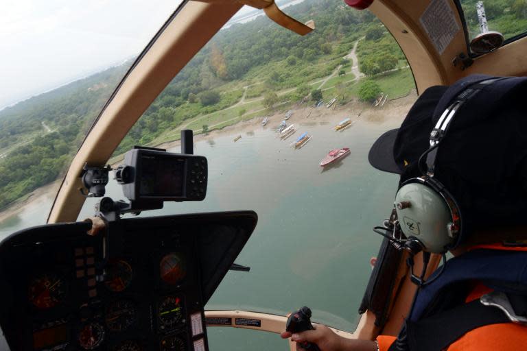 A rescue team search for seven Japanese tourists who went missing after leaving for a scuba diving trip in waters off the island of Bali on February 15, 2014