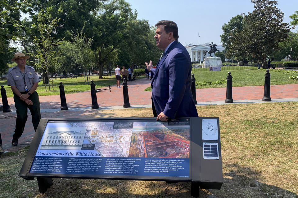 A new historical marker that addresses the construction of the White House by both enslaved people and paid laborers is displayed at the northern end of Lafayette Park on Wednesday, July 28, 2021, in Washington. The White House Historical Association on Wednesday unveiled three new historical markers at the northern end of Lafayette Park. (AP Photo/Ashraf Khalil)