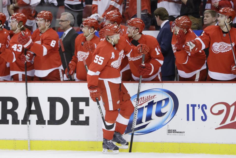 Detroit Red Wings defenseman Niklas Kronwall (55) is congratulated by teammates after his goal during the first period of Game 4 of a first-round NHL hockey playoff series against the Boston Bruins in Detroit, Thursday, April 24, 2014. (AP Photo/Carlos Osorio)