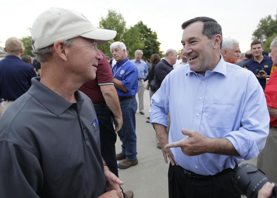 FILE - In this Aug. 3, 2012, file photo, Indiana Gov. Mitch Daniels, left, chats with Rep. Joe Donnelly, D-Ind., at the Indiana Pork Producers Ham Breakfast at the Indiana State Fair in Indianapolis. Donnelly is running for the U.S. Senate seat against Republican Richard Mourdock. Senate Republicans are jumping into Indiana's Senate race with a new ad, outdoing a recent buy from national Democrats as the parties battle for control of the Senate. Spending in Indiana has quickly escalated as Donnelly has stayed neck and neck with Republican Richard Mourdock since May. Mourdock's primary victory over Sen. Richard Lugar created the opening for Democrats in Indiana. (AP Photo/Michael Conroy)