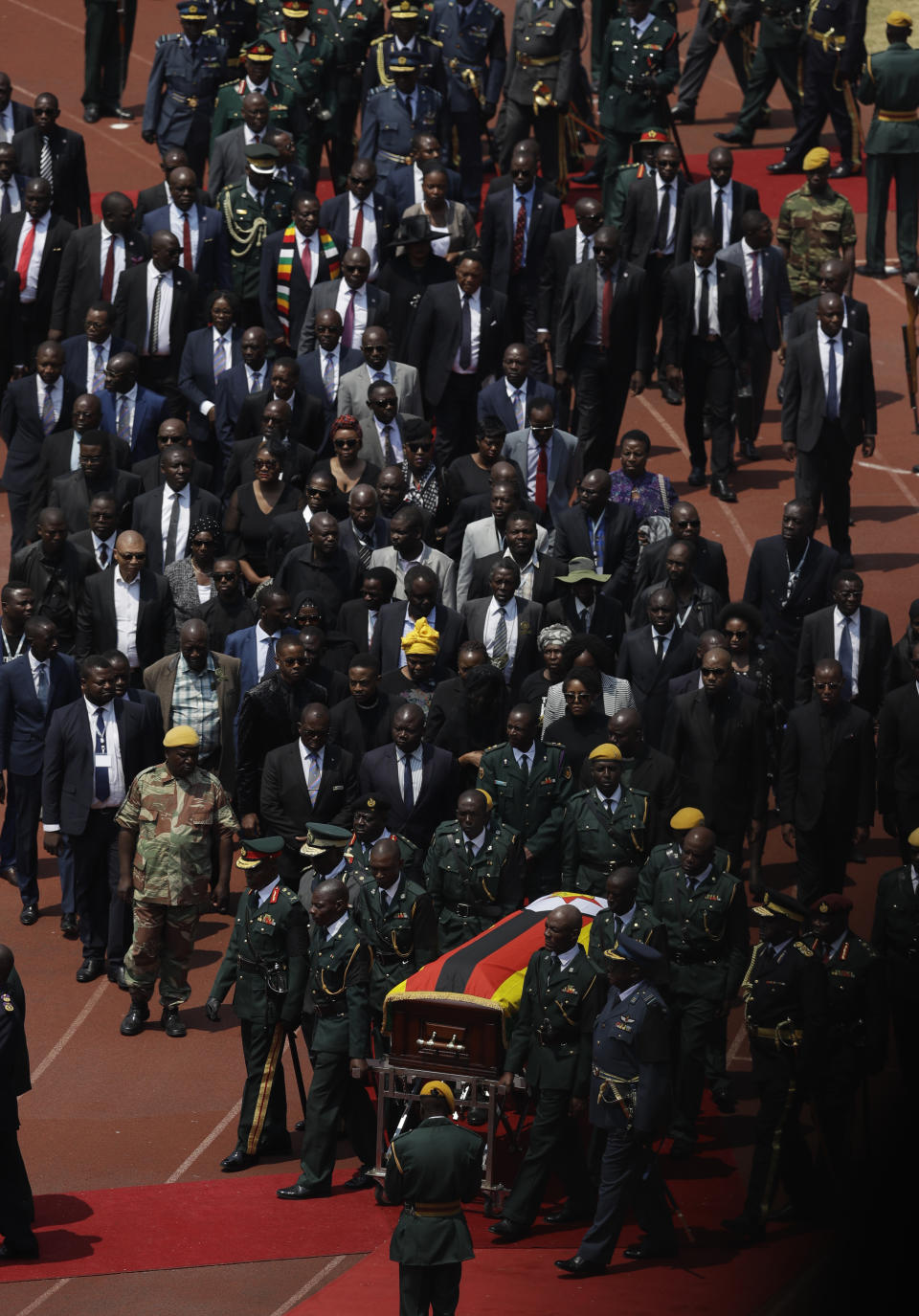 Former Zimbabwean President Robert Mugabe's coffin arrives for a state funeral for at the National Sports Stadium in Harare, Saturday, Sept. 14, 2019. African heads of state and envoys are gathering to attend a state funeral for Mugabe, whose burial has been delayed for at least a month until a special mausoleum can be built for his remains. (AP Photo/Themba Hadebe)