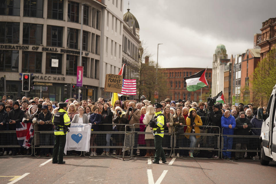 People gather outside Ulster University in Belfast, on Wednesday, April 12, 2023 ahead of a keynote speech by the US President Joe Biden, during his visit to the island of Ireland. (Niall Carson/PA via AP)