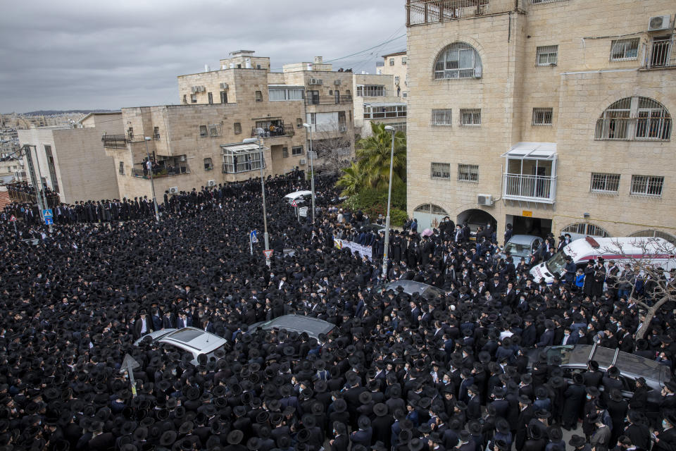 Thousands of ultra-Orthodox Jews participate in the funeral of Meshulam Soloveitchik, a prominent rabbi, flouting the country’s ban on large public gatherings amid the pandemic, in Jerusalem, Sunday, Jan. 31, 2021. The mass ceremony took place despite the country's health regulations banning large public gatherings, during a nationwide lockdown to curb the spread of the virus. (AP Photo/Ariel Schalit)