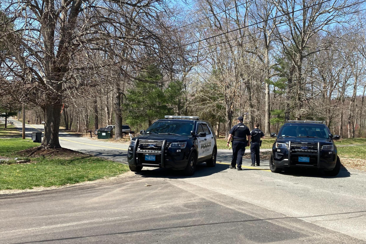Police block a road in North Dighton, Mass., Thursday, April 13, 2023. The FBI wants to question a 21-year-old member of the Massachusetts Air National Guard in connection with the disclosure of highly classified military documents on the Ukraine war, two people familiar with the investigation said Thursday. (AP Photo/Michelle R. Smith)