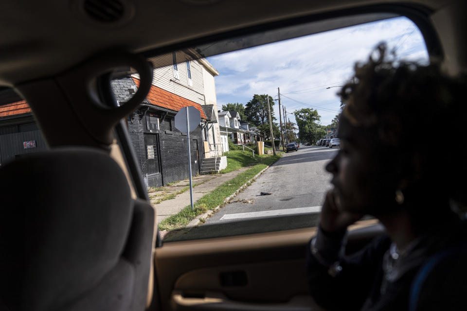 Navada Gwynn, 15, looks out of the car window as she rides past the intersection where her brother, Christian, was shot and killed in 2019 just blocks from their home in Louisville, Ky., Tuesday, Aug. 29, 2023, (AP Photo/David Goldman)