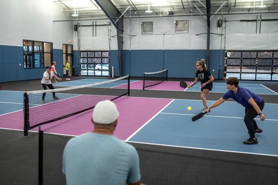 Kate Peterson, right, of Ypsilanti returns the ball during a match at the opening for the privately owned Wolverine Pickleball in Scio Township on Friday, December 1, 2023. The new, $7 million 39,000-square-foot indoor-outdoor facility will be the state's largest.